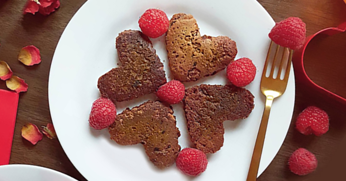 Heart-shaped chocolate pancakes with raspberries